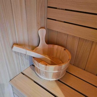 Wooden sauna room bucket with ladle and handle.