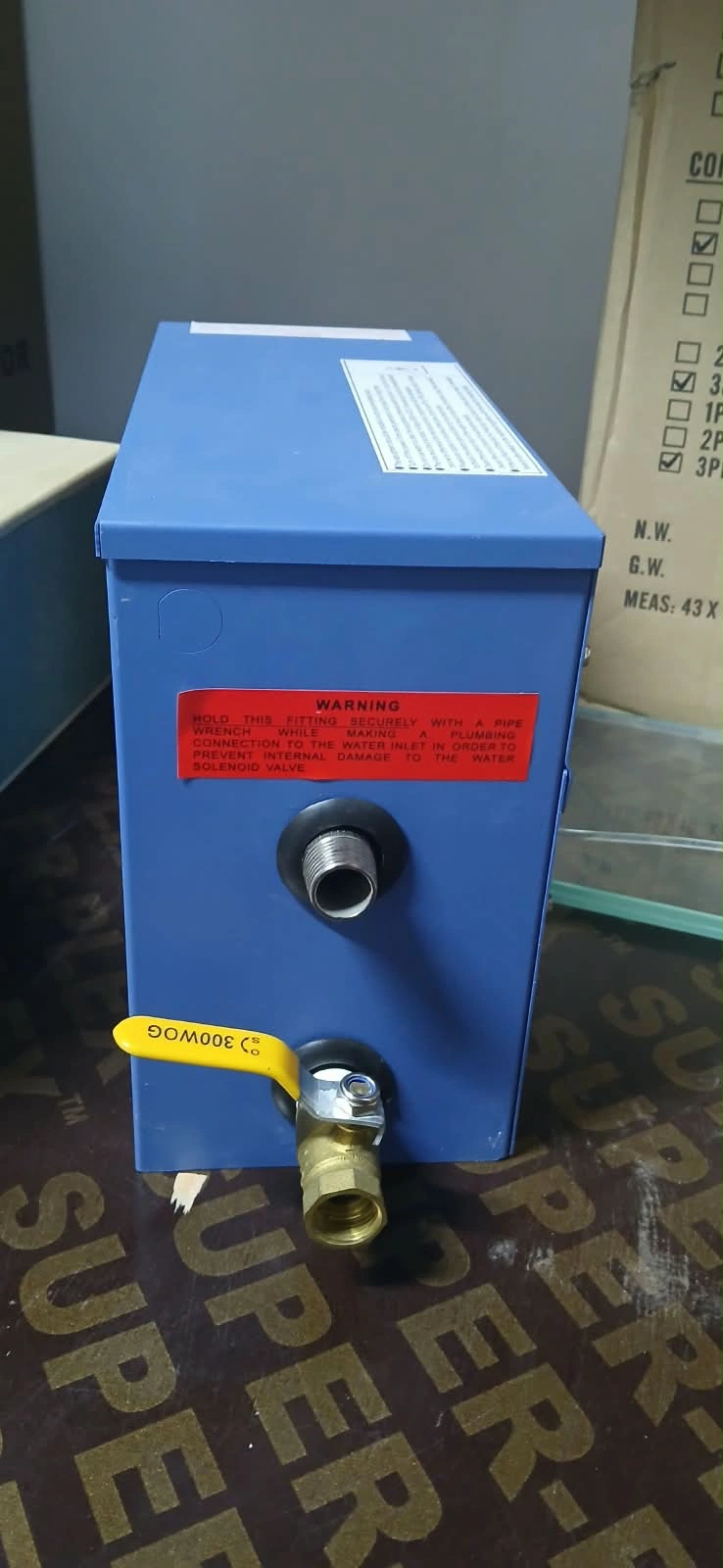Original photo of the compact blue ST-30 steam generator with its metal connection and yellow drain valve